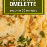 Image of a fluffy spinach omelette garnished with chopped chives, served on a plate. Spinach Omelette Recipe - Ready in 20 minutes. Learn how to cook this healthy breakfast with simple steps for a nutritious start to your day.