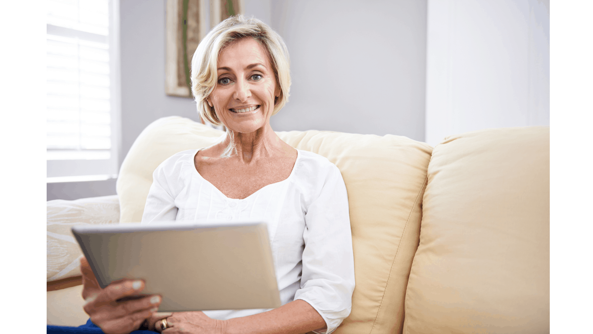 older woman seated with tablet device