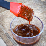 Grilling brush dipped in BBQ sauce recipe with molasses
