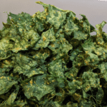 Homemade crispy and cheesy kale chips in oven or dehydrator, ready to eat