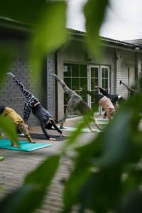 group yoga in an outdoor setting might be your gym happiness sweet spot this year
