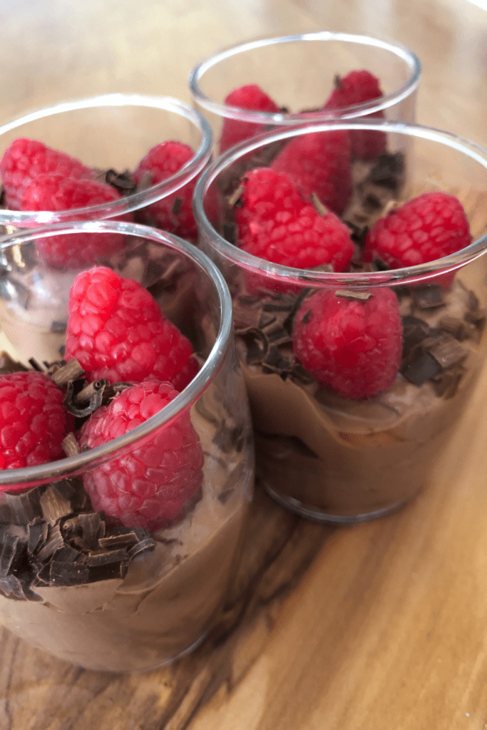 Silken tofu chocolate mousse with fresh raspberries garnished with chocolate curl