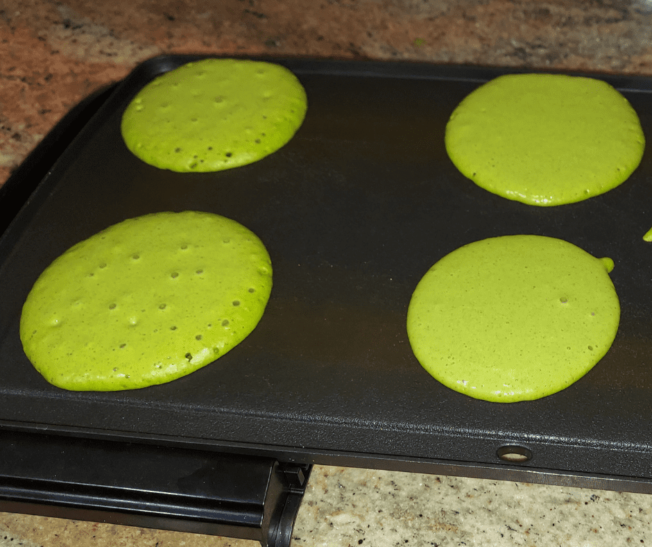 Green pancakes get their color from spinach, on the griddle and ready in under 15 minutes