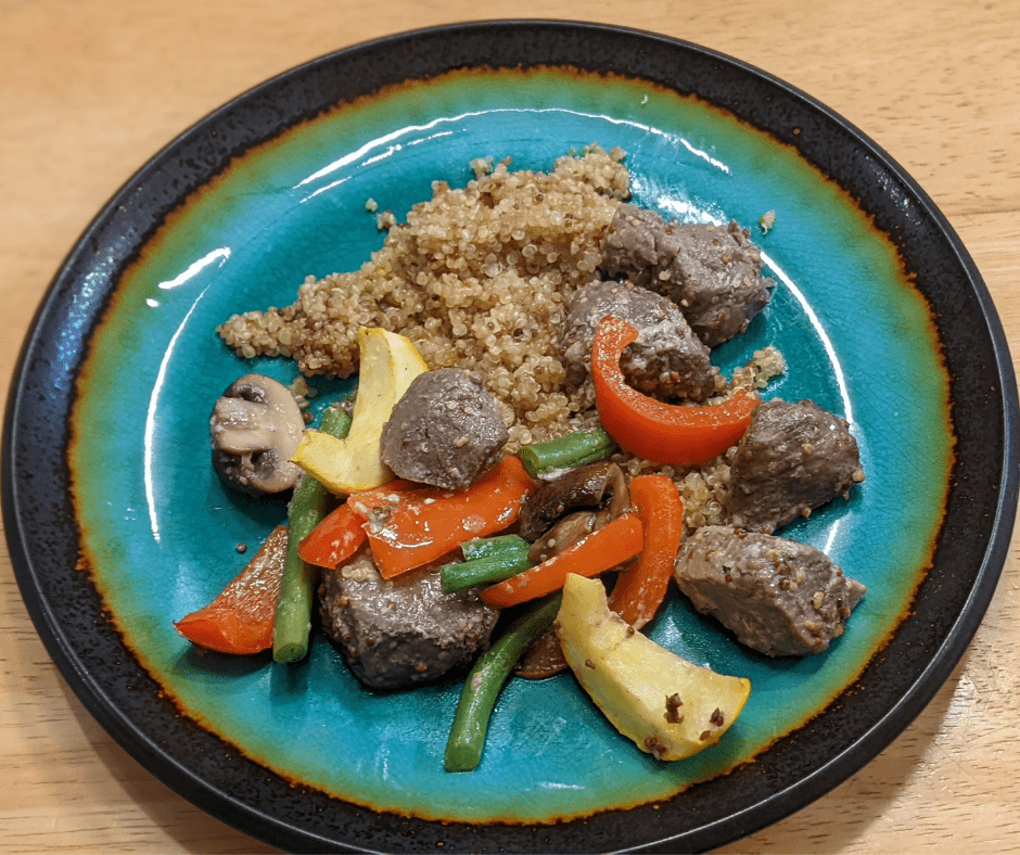 Serving suggestion for deconstructed beef brochettes over seasoned quinoa