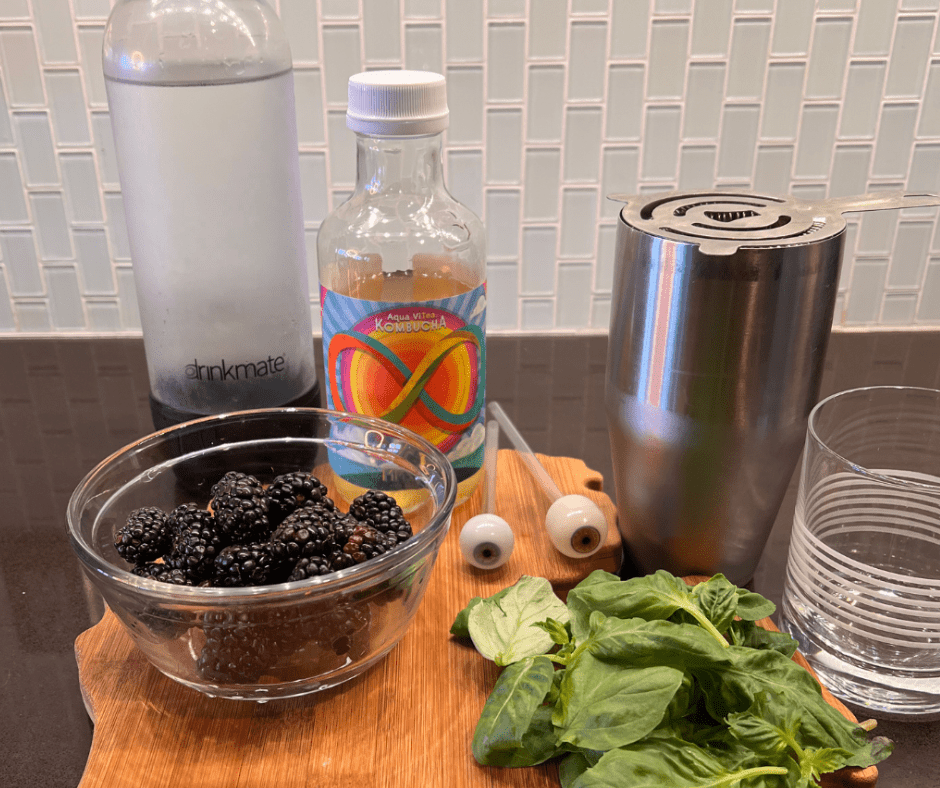 Ingredients for Basil Blackberry Smash mocktail include fresh berries and basil, plus kombucha and club soda.