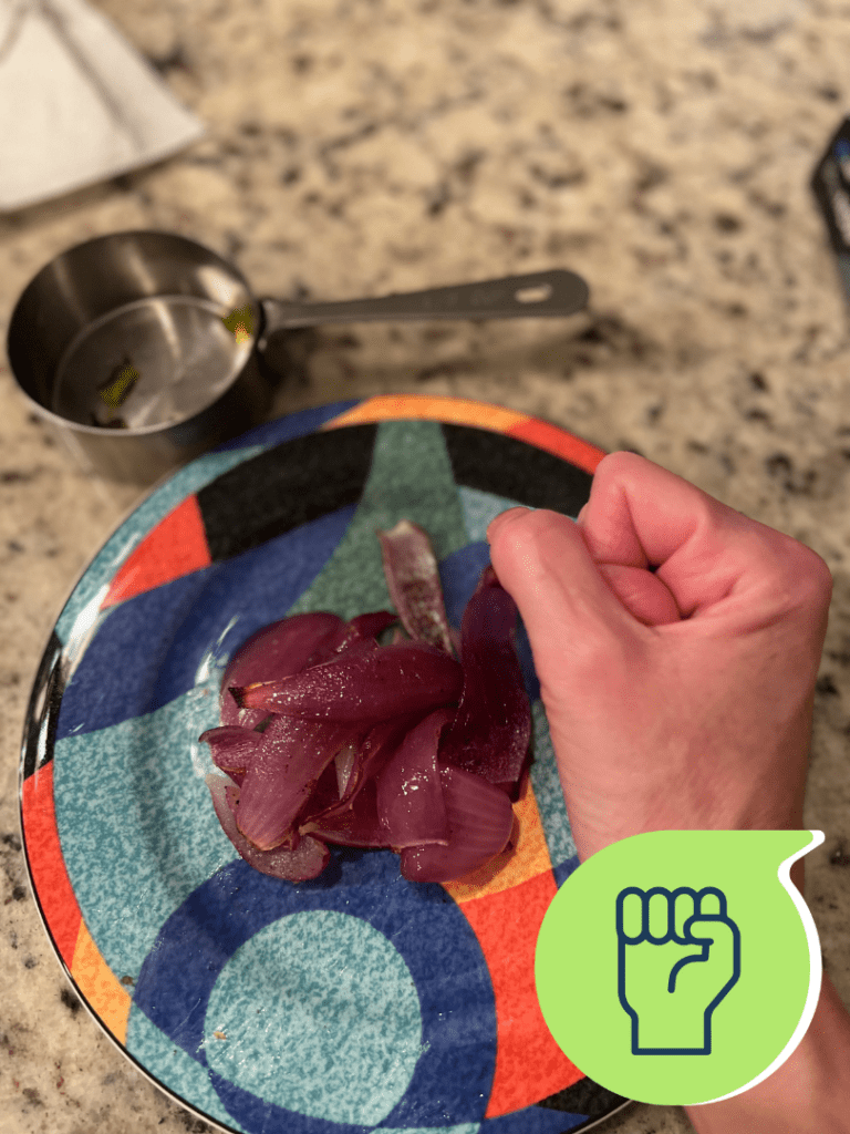 Portion size hand of red onions measuring food with hand.