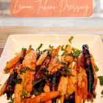 An easy recipe for harissa roasted carrots drizzled with lemon tahini sauce