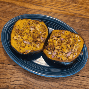 Vegetarian acorn squash recipe, roasted stuffed with Field Roast sausage, apple, and quinoa