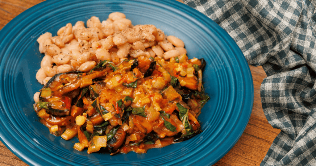 Sauteed butternut squash, chard, and harissa sauce is a well rounded vegetarian meal when paired with lentils or butter beans