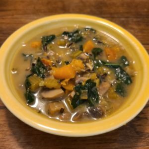 A bowl of soup made with wild rice and winter vegetables