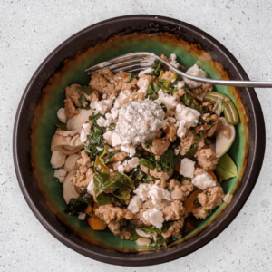 Mediterranean power bowl - Greek chicken bowl on a bed of fresh vegetables with tzatziki sauce