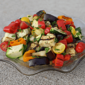 Grilled vegetable salad for cookout: grilled eggplant, zucchini, mushrooms, and bell peppers with balsamic vinaigrette