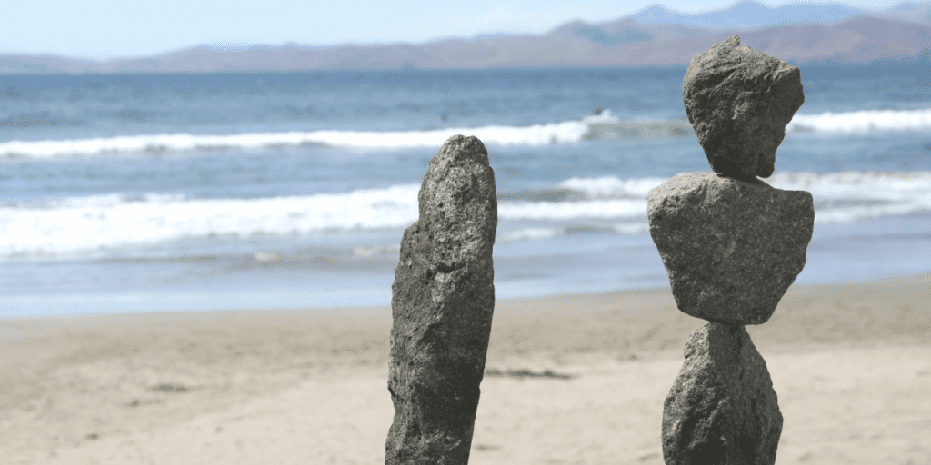 health in balance balancing rocks by ocean