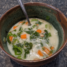Bowl of homemade white bean soup with spinach, carrots and potatoes made in an instant pot.